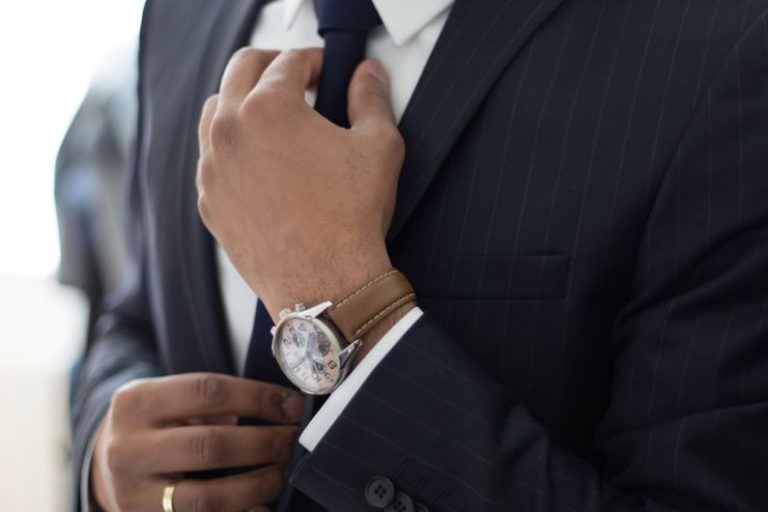 Suit - man wearing watch with black suit