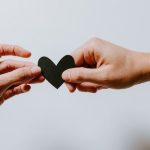 Comfort - two person holding papercut heart