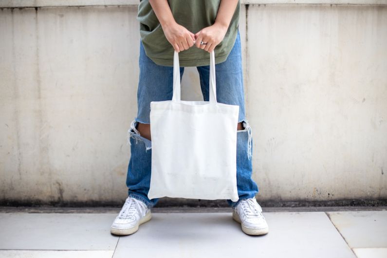Bag - person in blue denim jeans holding white tote bag