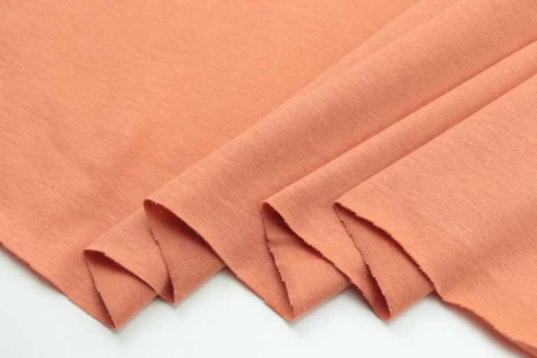 Fabrics - a close up of a plain orange fabric