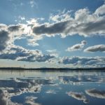 Weather - blue sky and white clouds over lake