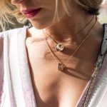 Jewelry - woman wearing gold-colored ring pendant necklaces