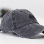 Hat - gray baseball cap on white surface