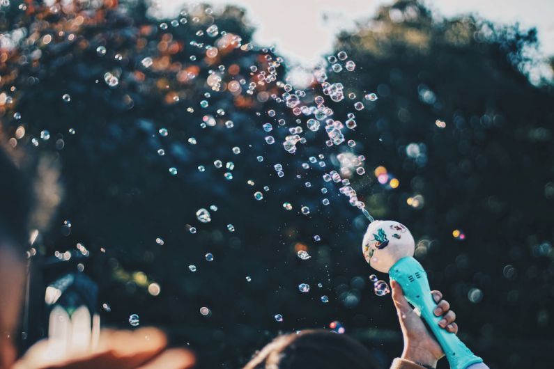 Outdoor Date - person's hand holding bubble toy